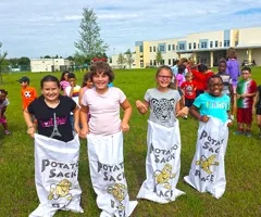 Kids racing in potato sacks