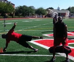 Athletes doing agility drills on a football field